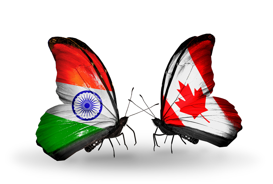 Two butterflies with flags on wings as symbol of relations India and Canada